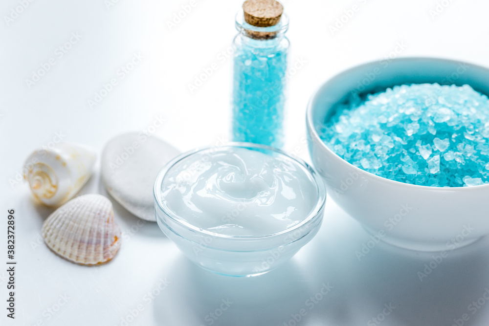 blue sea salt and body cream on white desk background