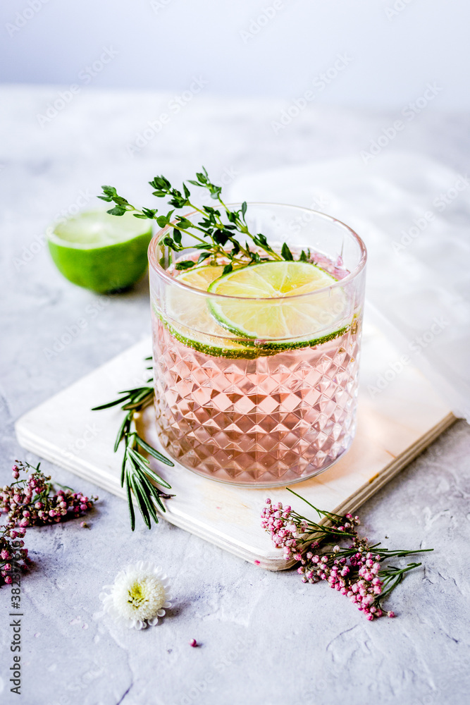 fresh homemade drink with flowers and lime on kitchen background