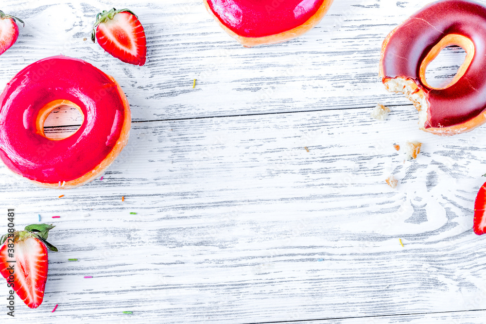 strawberry and chocolate donuts flat lay on wooden background top view mockup