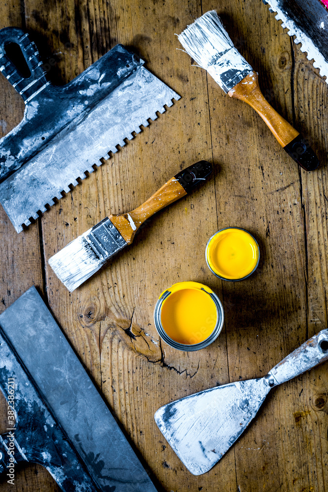 builder work with professional repairing implements set on wooden background top view