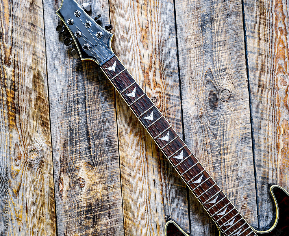 Electric guitar body on wooden background vintage look