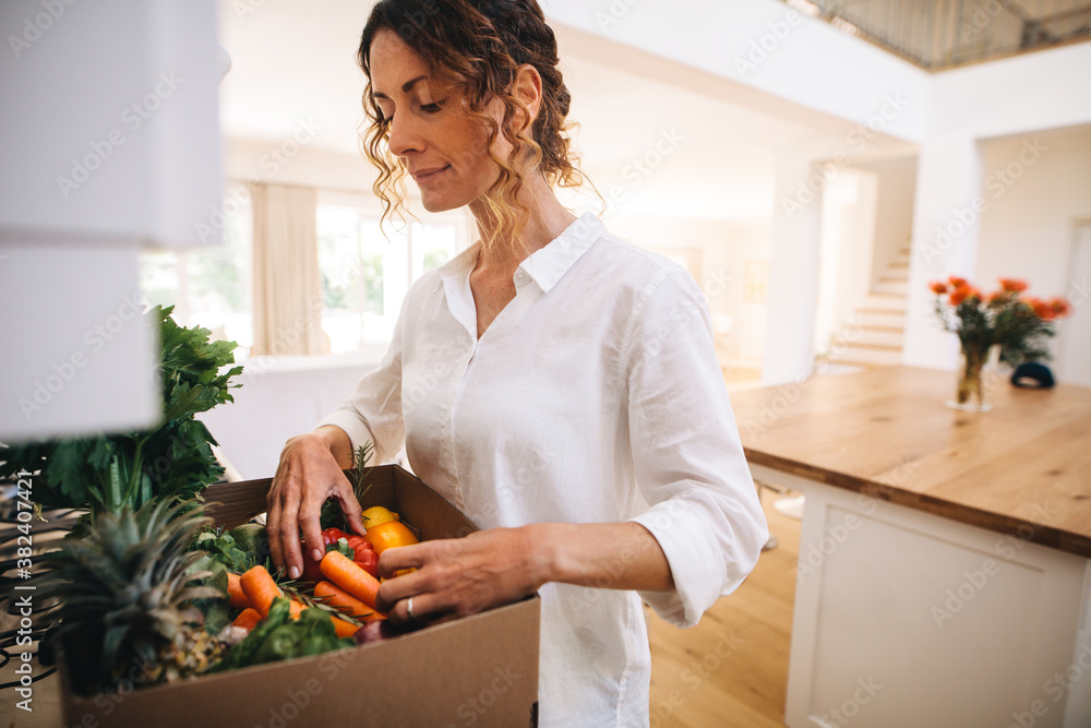 Woman checking online purchased groceries