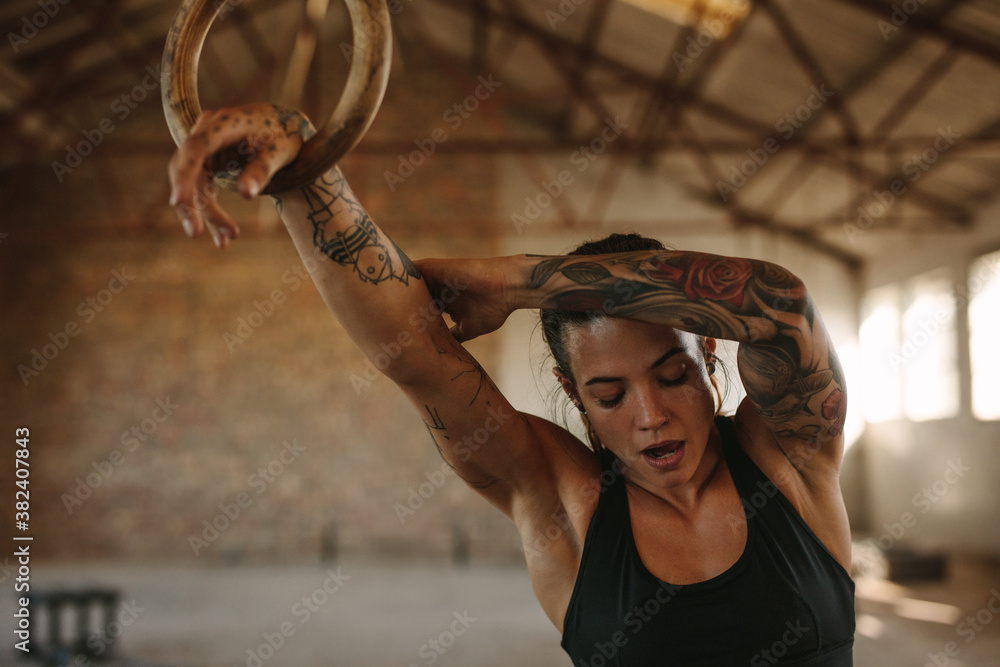 Woman resting after gymnastic rings workout