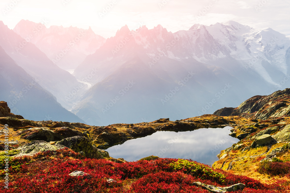 Colourful autumn landscape with Chesery lake (Lac De Cheserys) and snowy Monte Bianco mountains rang