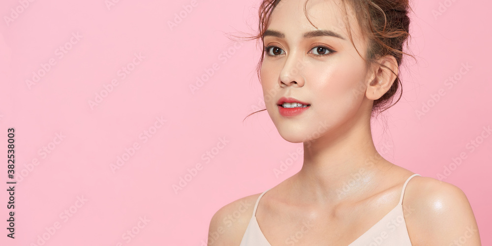 A beautiful, sweet, well-groomed girl on a bright pink background