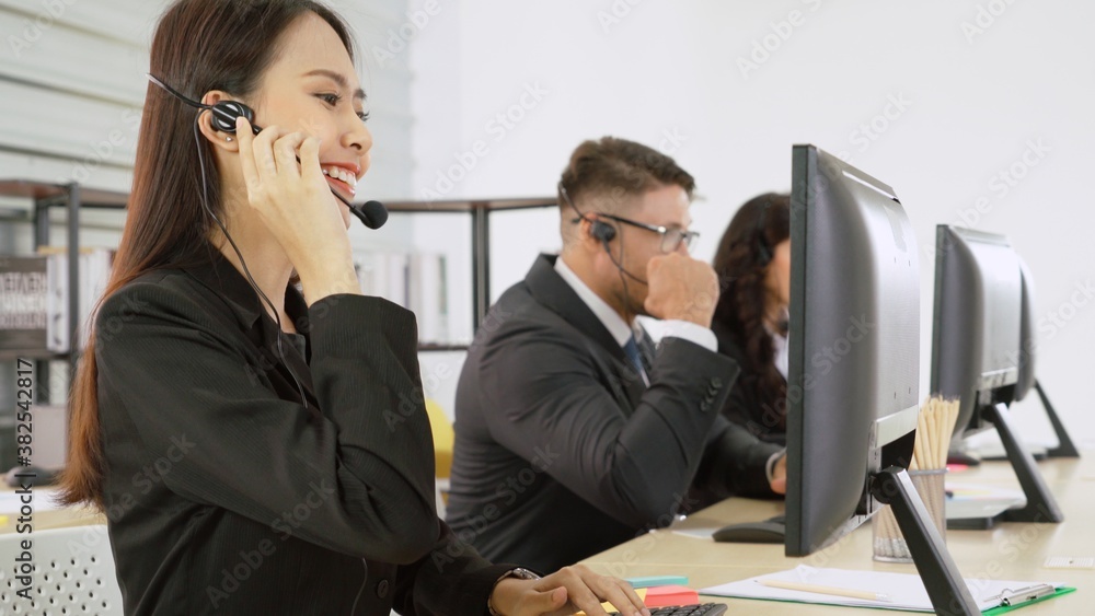 Business people wearing headset working in office to support remote customer or colleague. Call cent