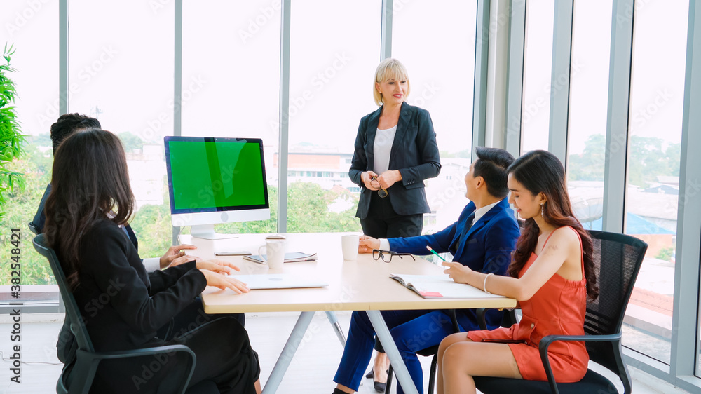 Business people in the conference room with green screen chroma key TV or computer on the office tab