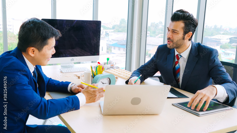 Two business people talk project strategy at office meeting room. Businessman discuss project planni