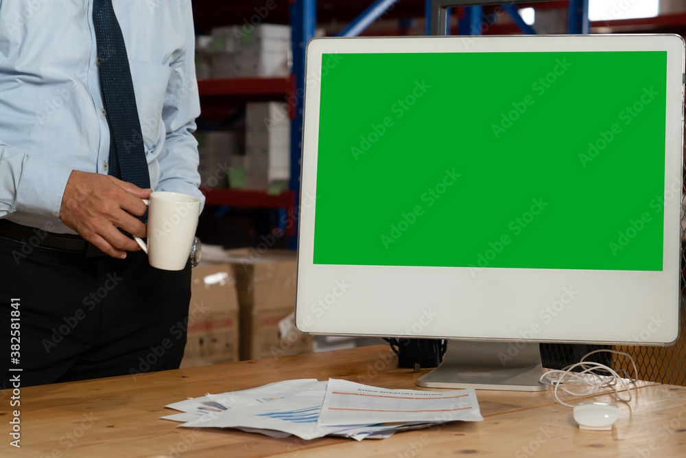 Computer with green screen display in warehouse storage room . Delivery and transportation software 