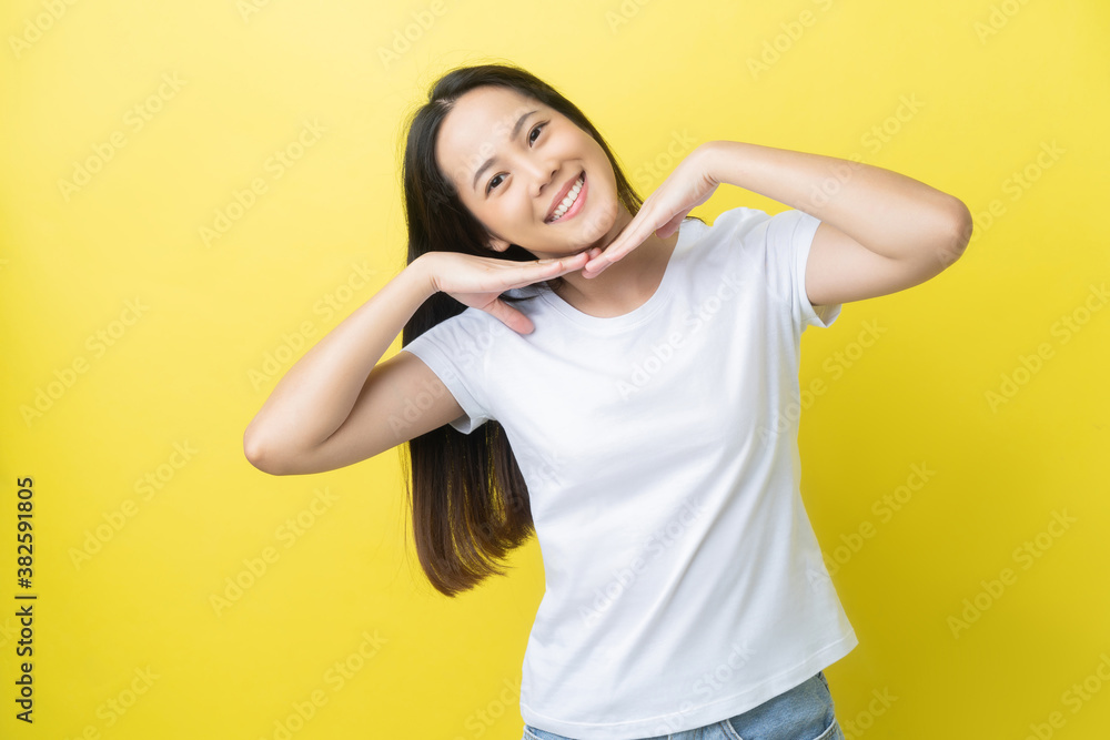 Beautiful asian woman She shows confidence On a yellow background