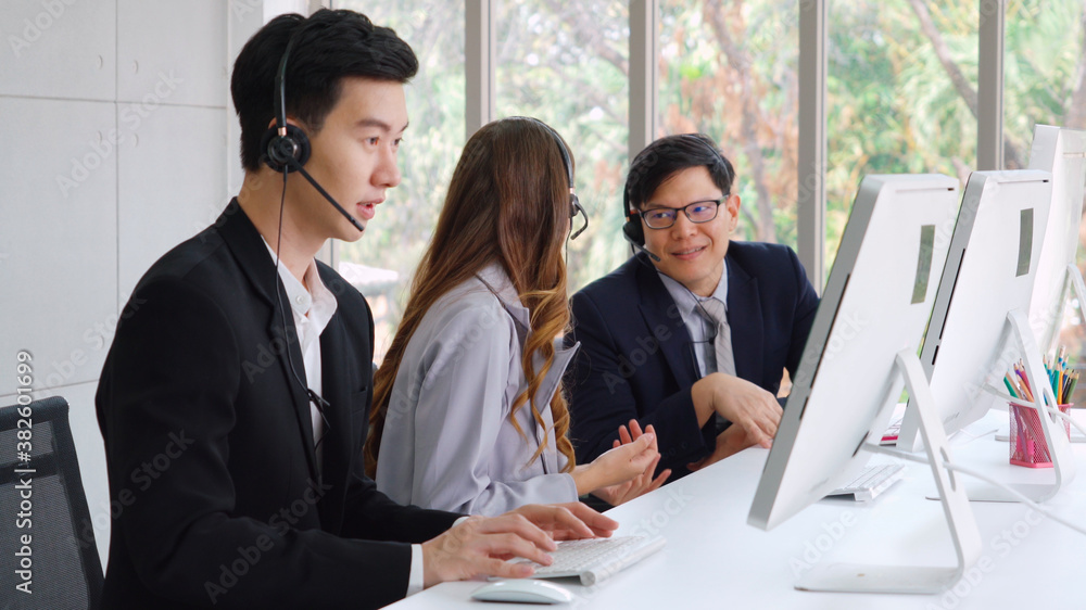 Business people wearing headset working in office to support remote customer or colleague. Call cent