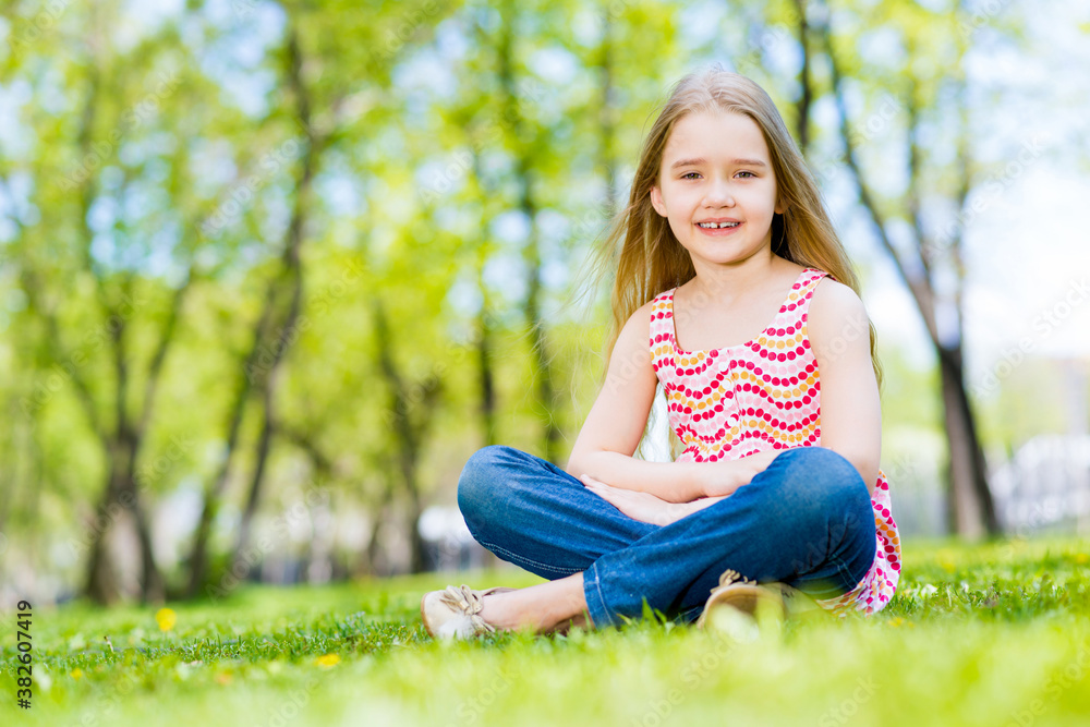 portrait of a smiling girl in a park