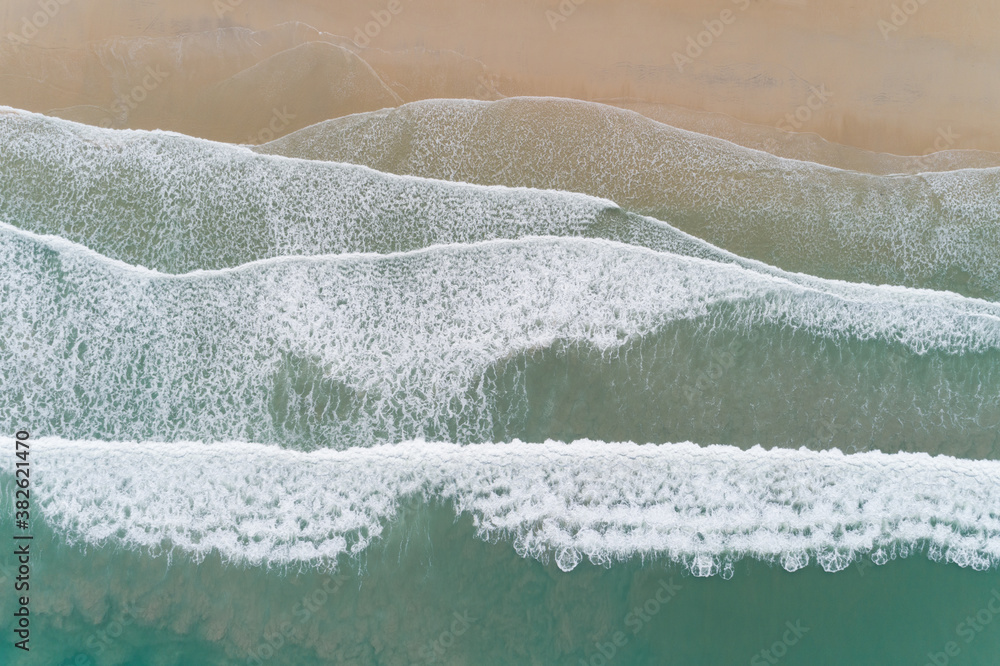 Aerial view sandy beach and crashing waves on sandy shore Beautiful tropical sea in the morning summ