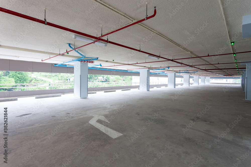 Arrow sign Parking garage industrial building,Empty parking in apartment or supermarket background.