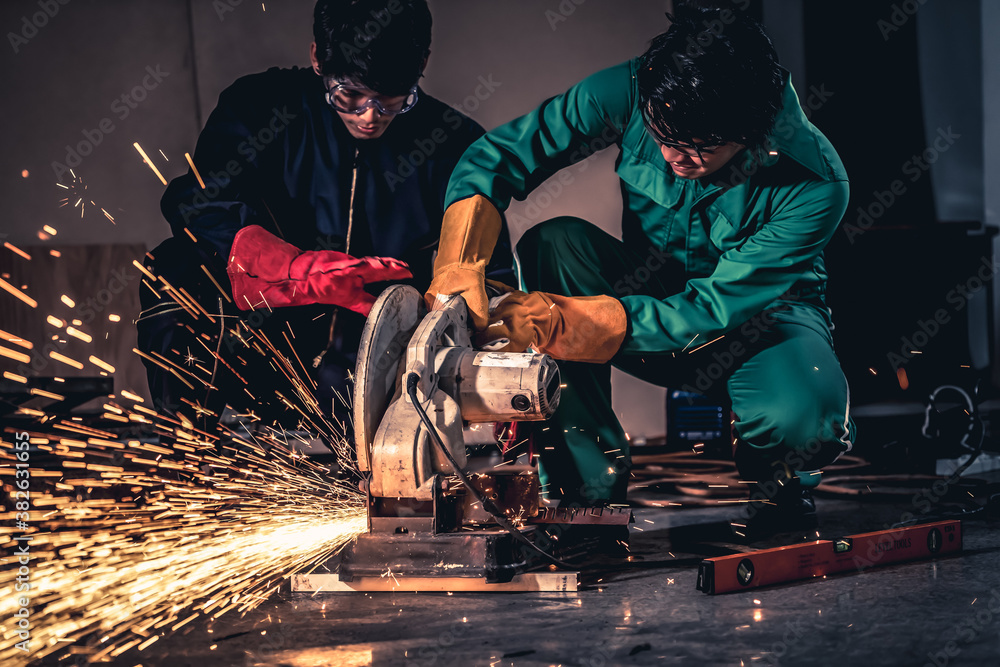 Professional mechanic man is cutting steel metal with rotating carbon blade cutter. Steel industry a