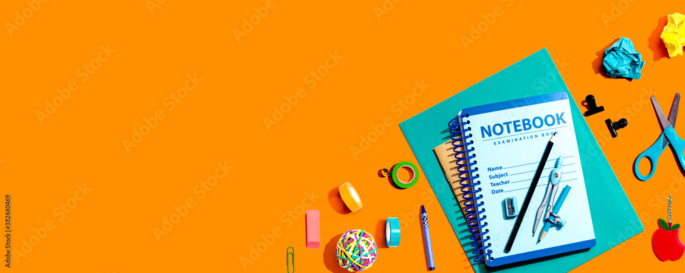 Notebooks with school supplies overhead view - flat lay