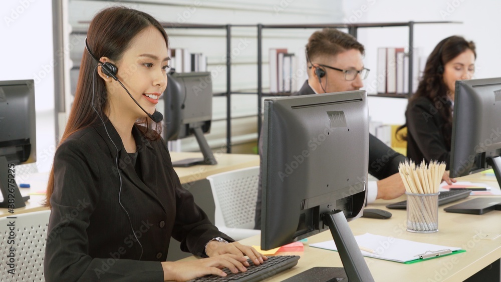 Business people wearing headset working in office to support remote customer or colleague. Call cent