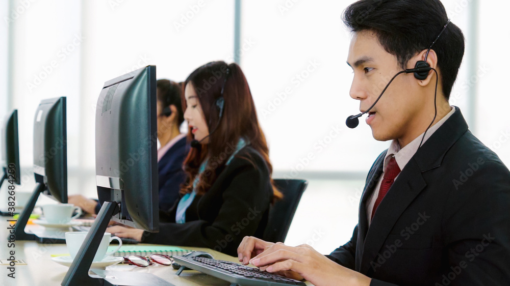 Business people wearing headset working in office to support remote customer or colleague. Call cent