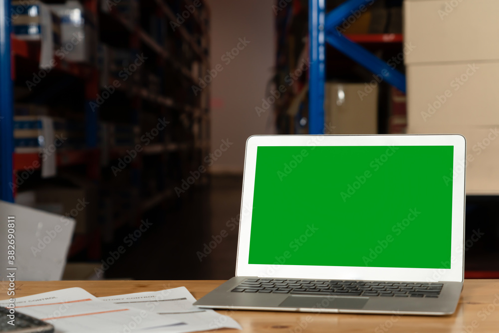 Computer with green screen display in warehouse storage room . Delivery and transportation software 