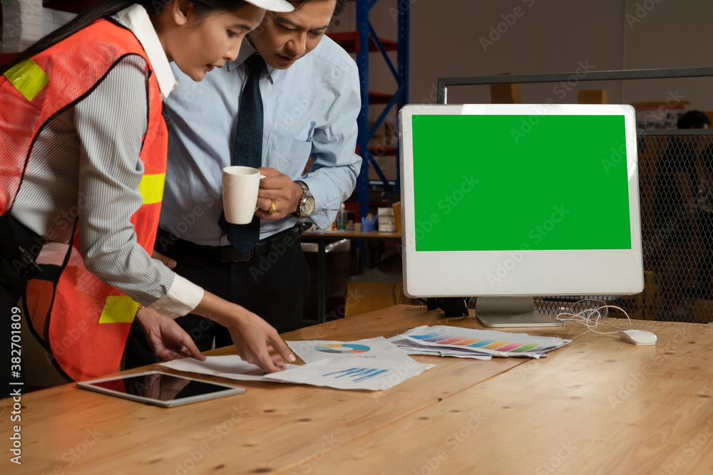 Computer with green screen display in warehouse storage room . Delivery and transportation software 