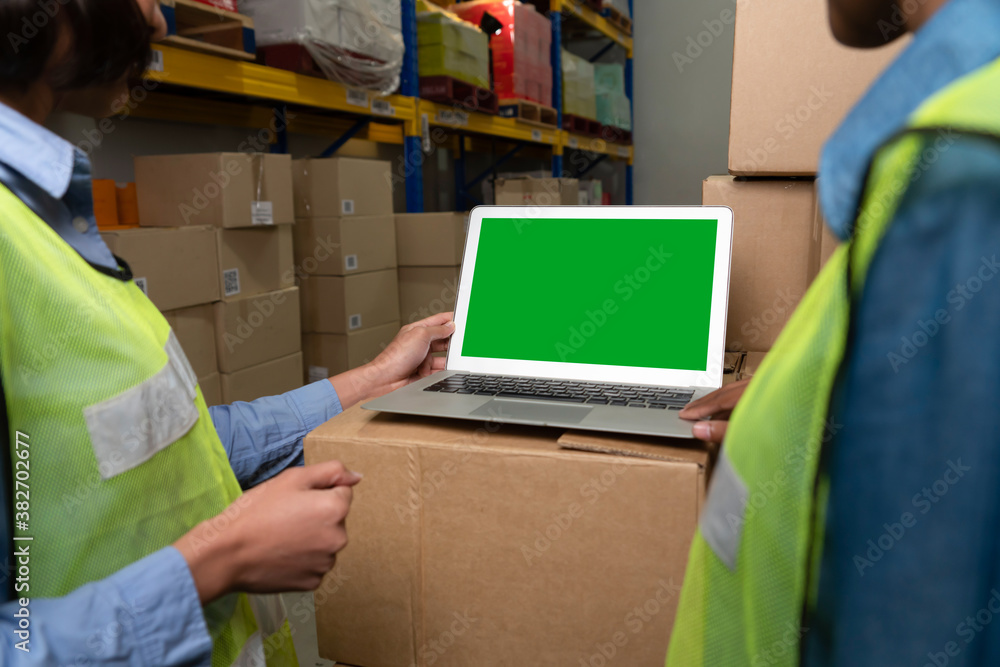 Computer with green screen display in warehouse storage room . Delivery and transportation software 