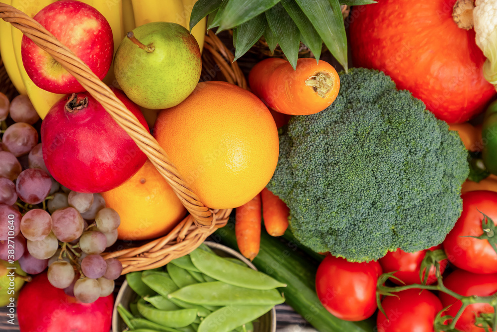 Group vegetables and Fruits Apples, grapes, oranges, pineapples, bananas in a wooden basket with car