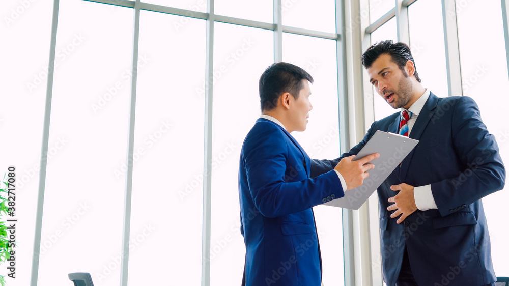 Two business people talk project strategy at office meeting room. Businessman discuss project planni