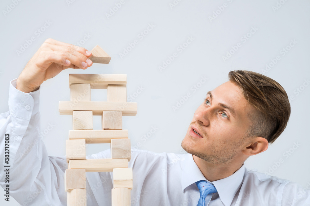 Businessman making tower