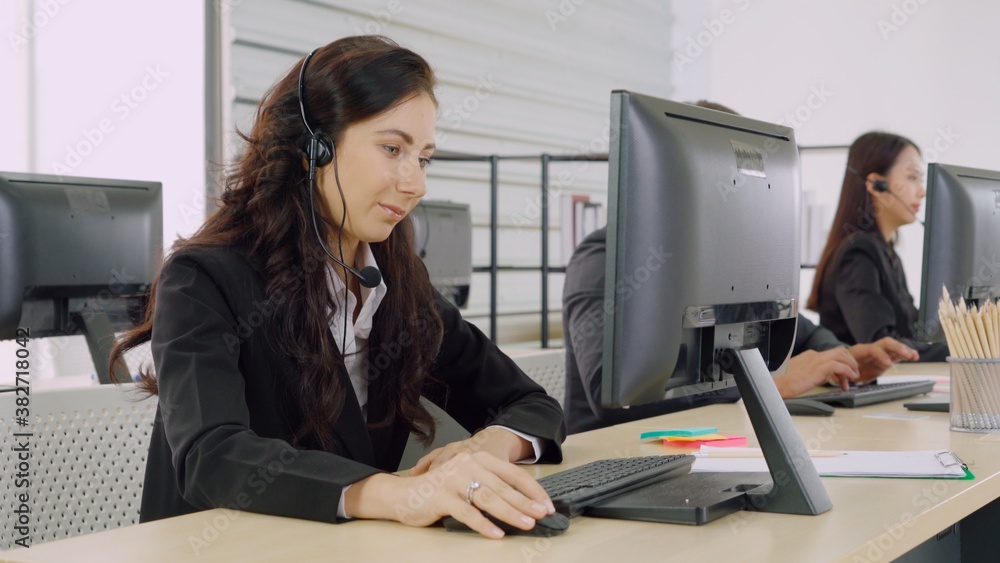 Business people wearing headset working in office to support remote customer or colleague. Call cent