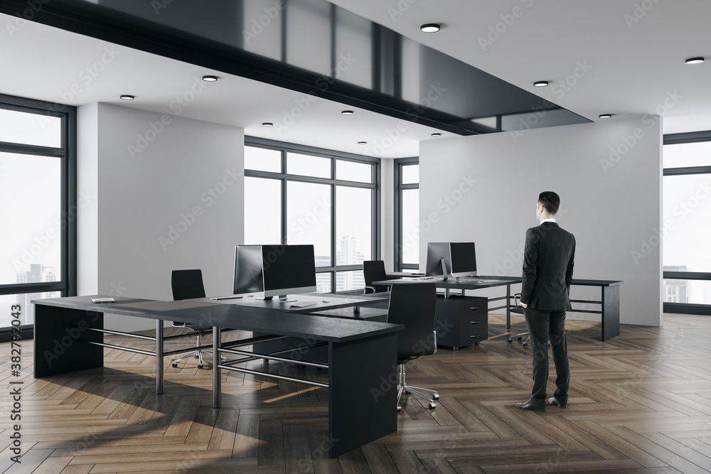 Young businessman standing сoworking office interior