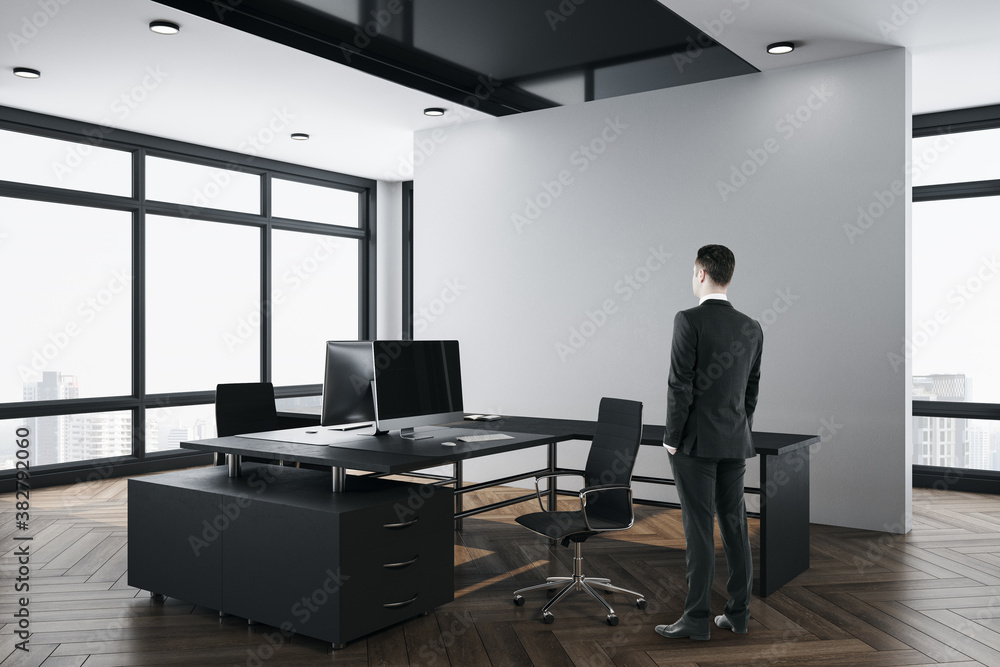 Young businessman standing in office interior