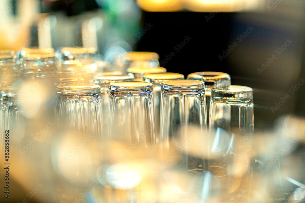 close up glasses rack in bar vintage color tone withh blur bokeh background