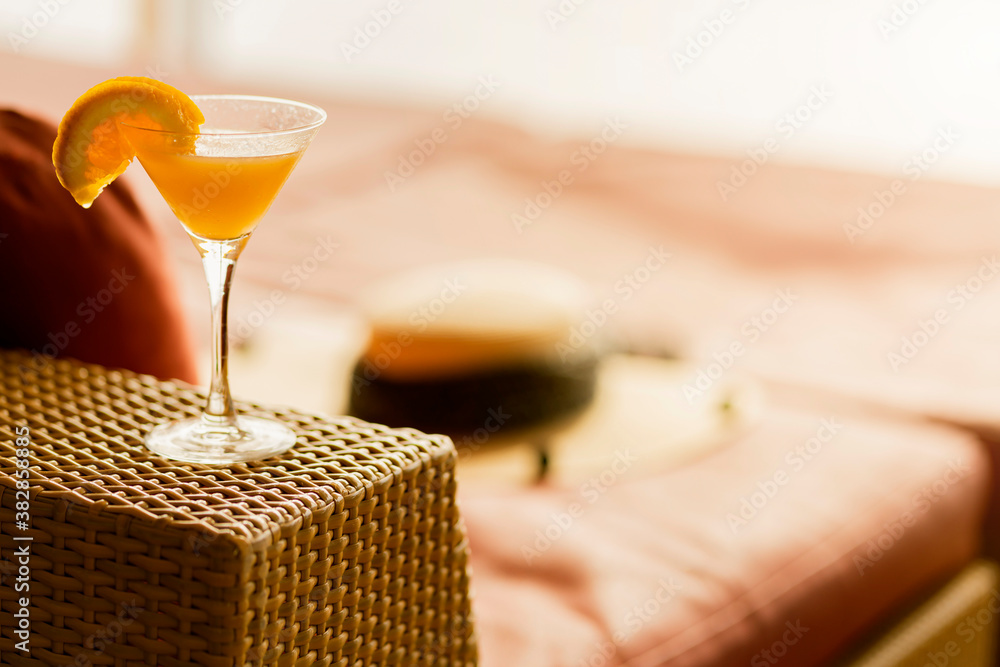 orange cocktail glasses on rattan bench at wooden cruise deck summer vacation moment relax and peace