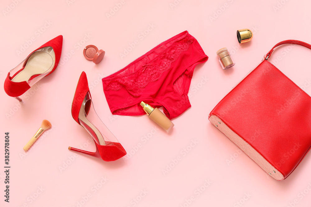 Stylish female panties with shoes and accessories on color background