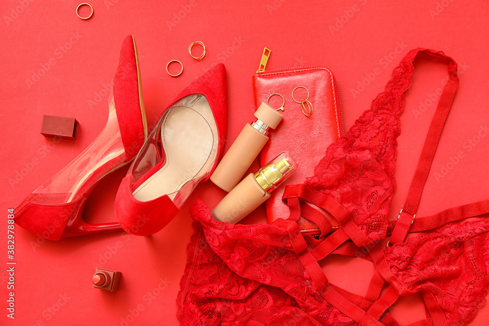 Stylish female lingerie with shoes and accessories on color background