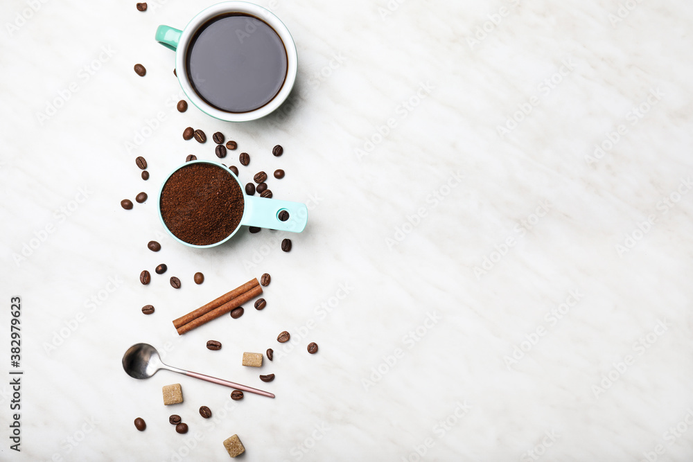 Cup of coffee with powder and beans on white background