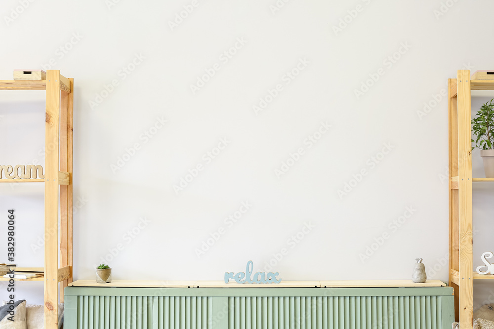 Stylish interior of room with stand and wooden racks