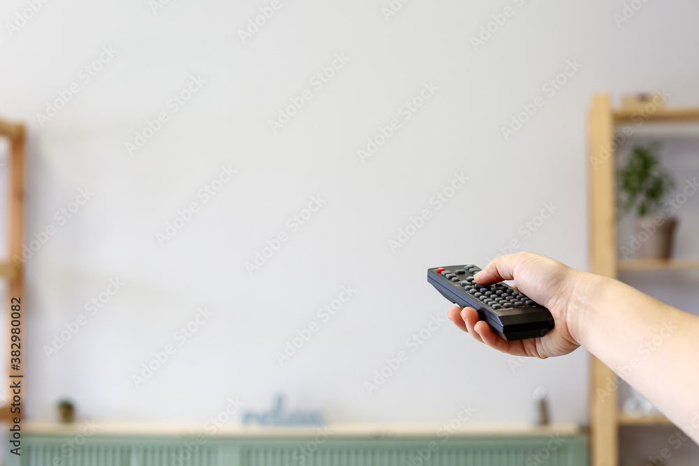 Young woman watching TV at home