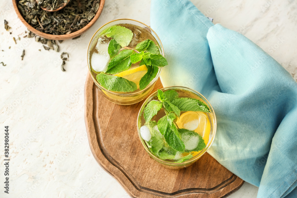 Glasses of tasty cold ice tea on table