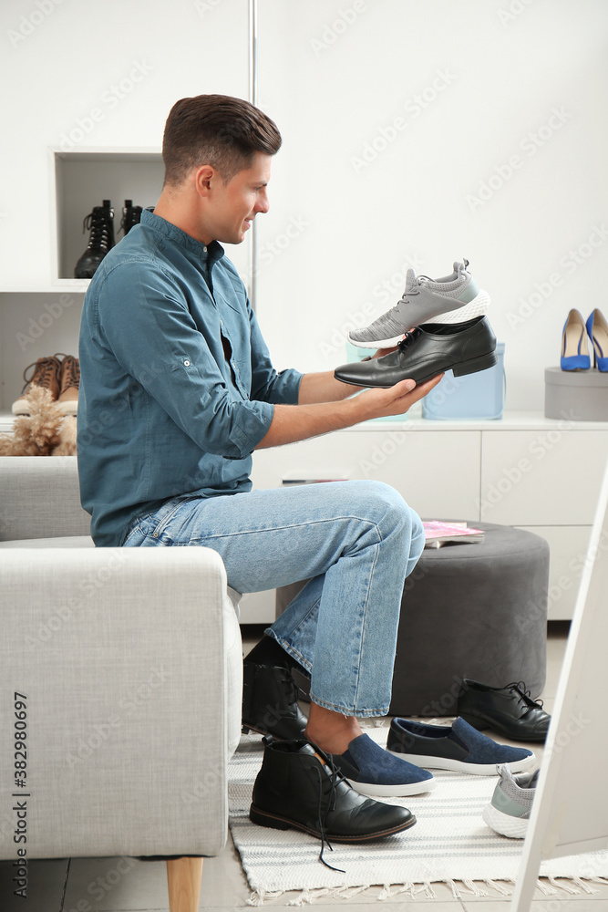 Man choosing new shoes in modern store