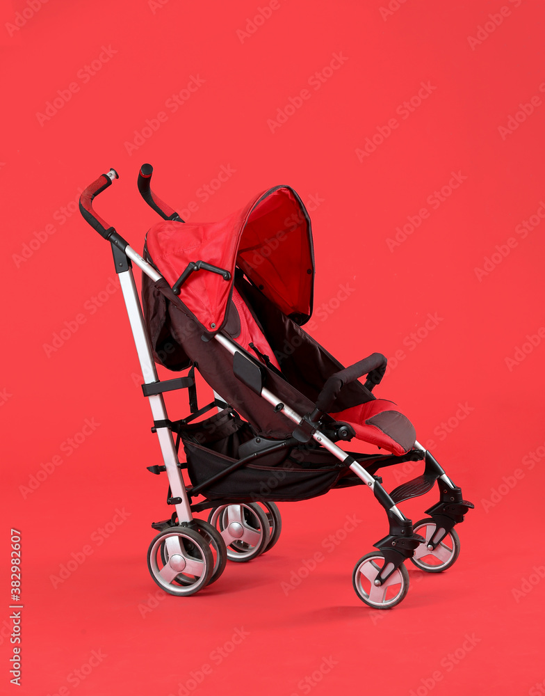 Modern baby stroller on color background