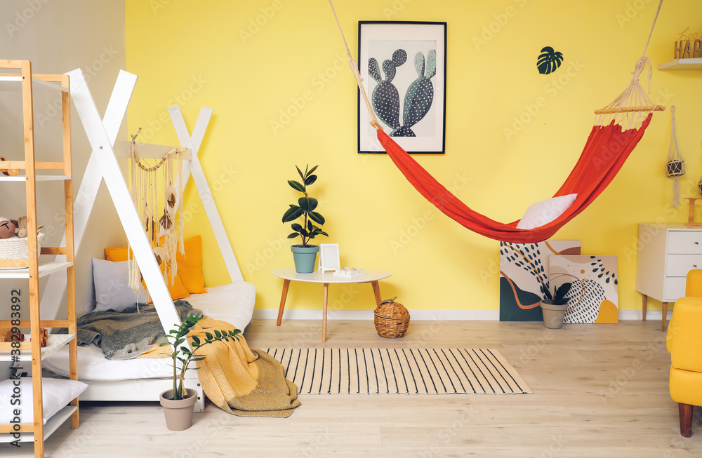 Interior of modern childrens room with comfortable bed