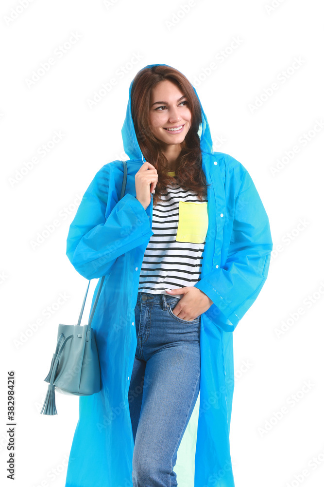 Beautiful young woman in raincoat on white background