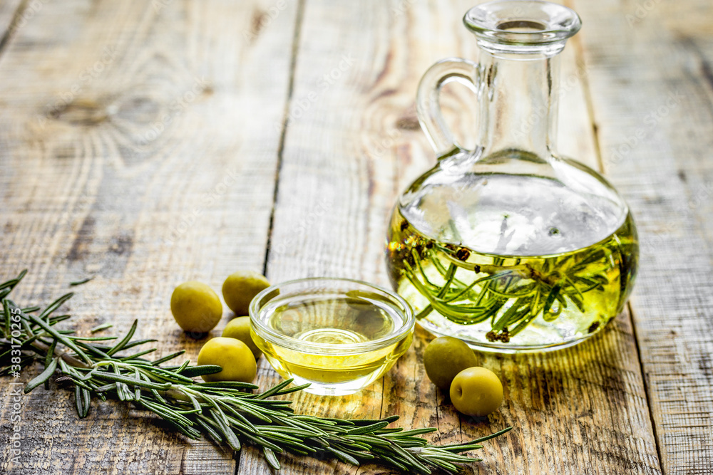 oil in carafe with spices and olive on wooden background mock-up