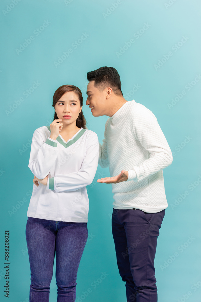 young Asian couple whisper, closeup portrait.