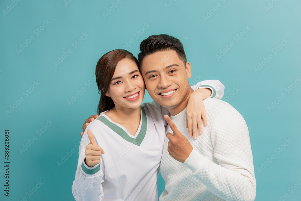 Happy young couple two thumbs up sign