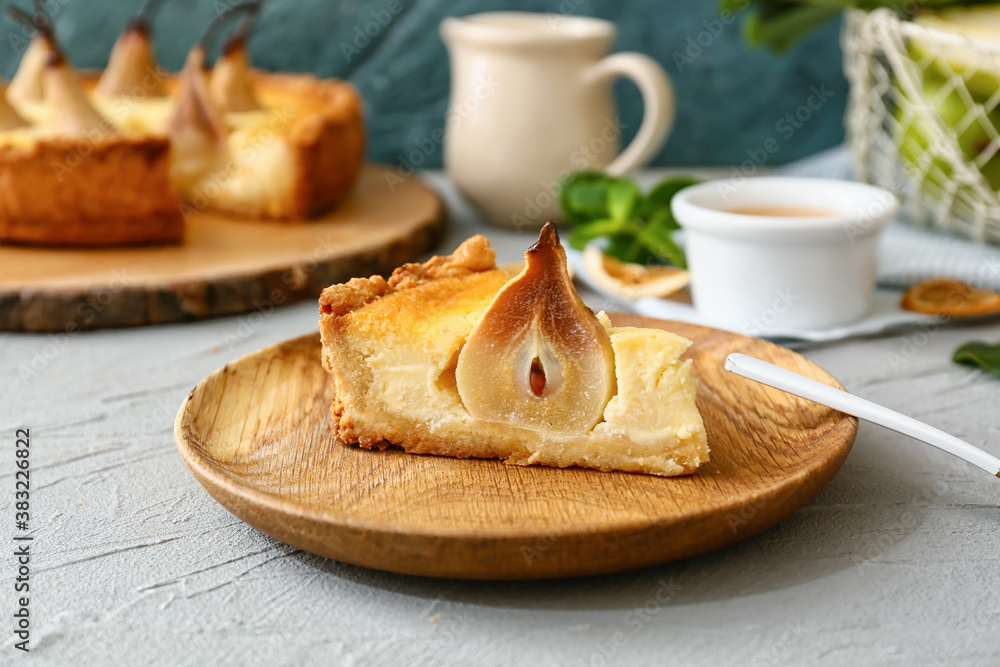 Plate with tasty pear cake on table