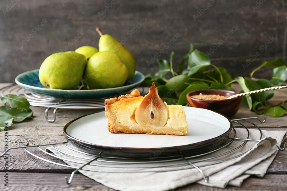 Plate with tasty pear cake on table