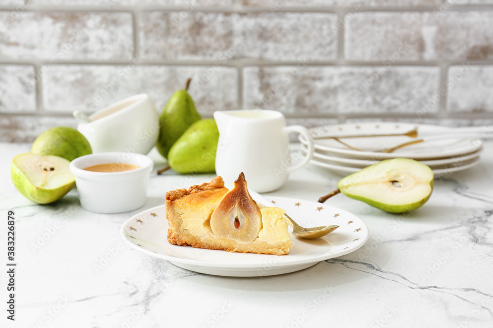 Plate with tasty pear cake on table