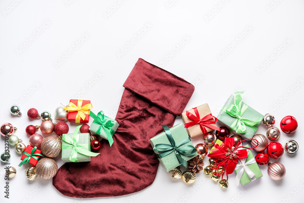 Composition with Christmas sock on white background